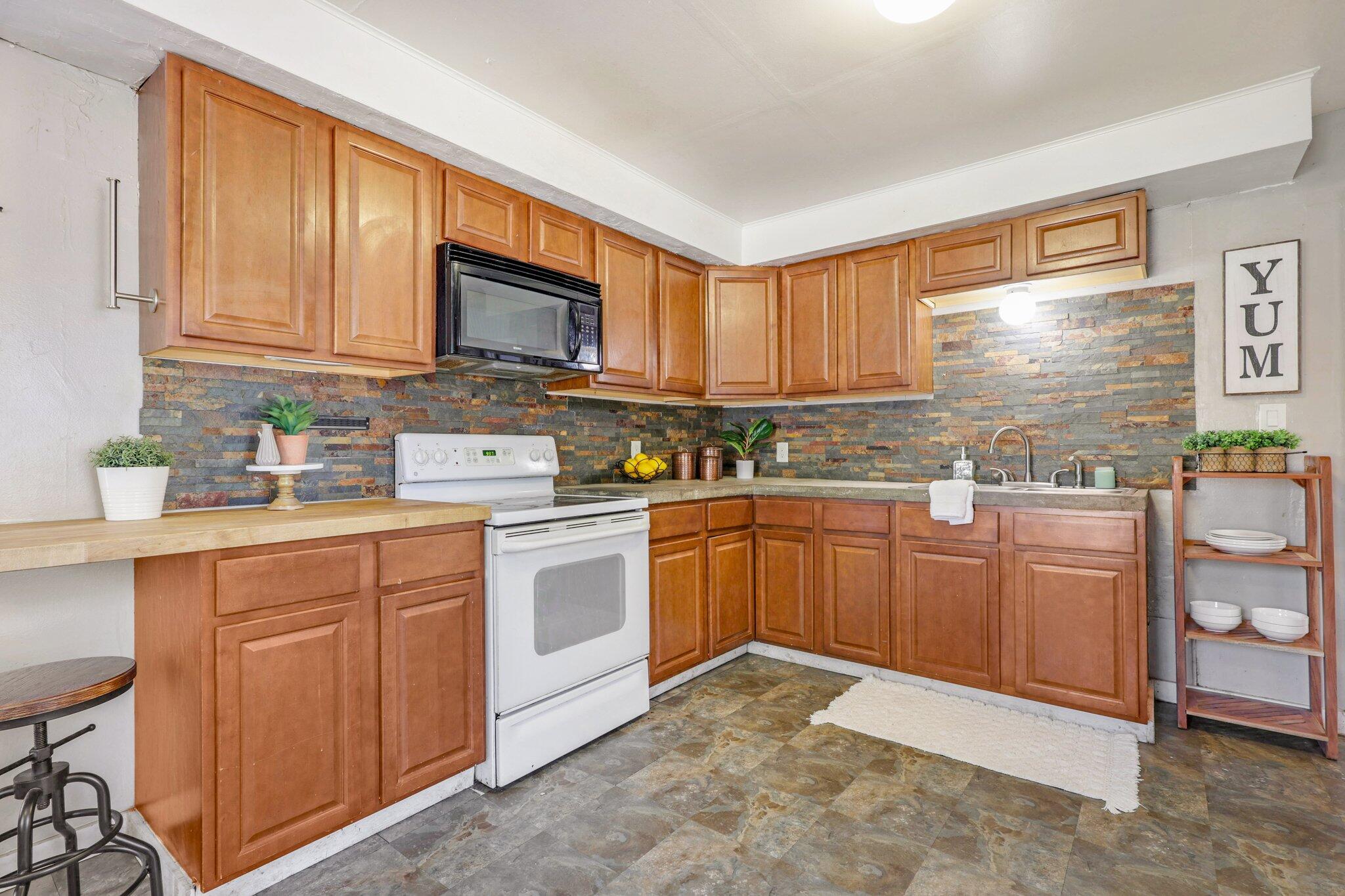 7699 Happy Valley Road Anderson, CA 96007 - Photo 24 of 49 a kitchen with stainless steel appliances granite countertop a stove sink and cabinets