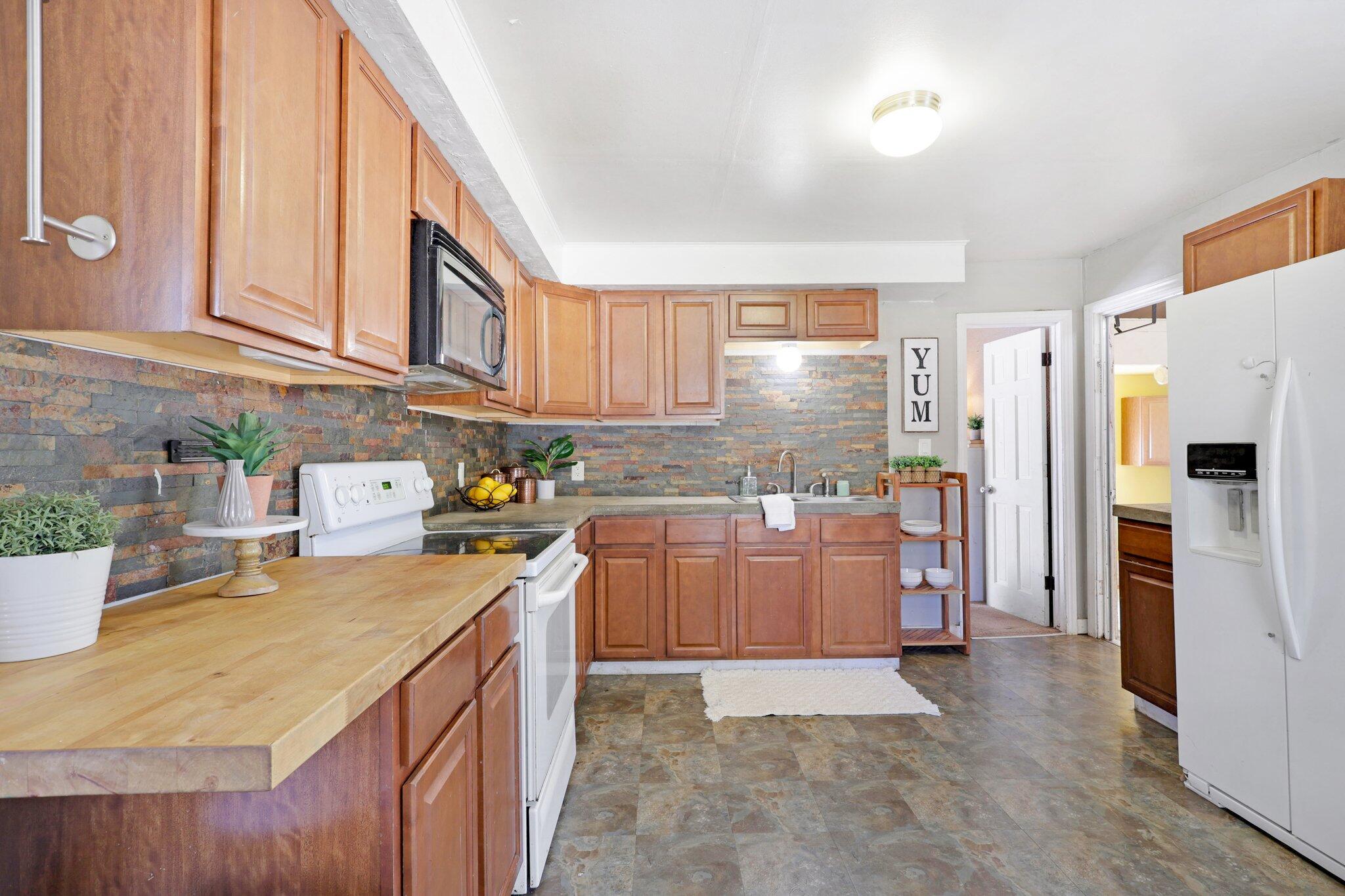 7699 Happy Valley Road Anderson, CA 96007 - Photo 26 of 49 a kitchen with refrigerator and cabinets