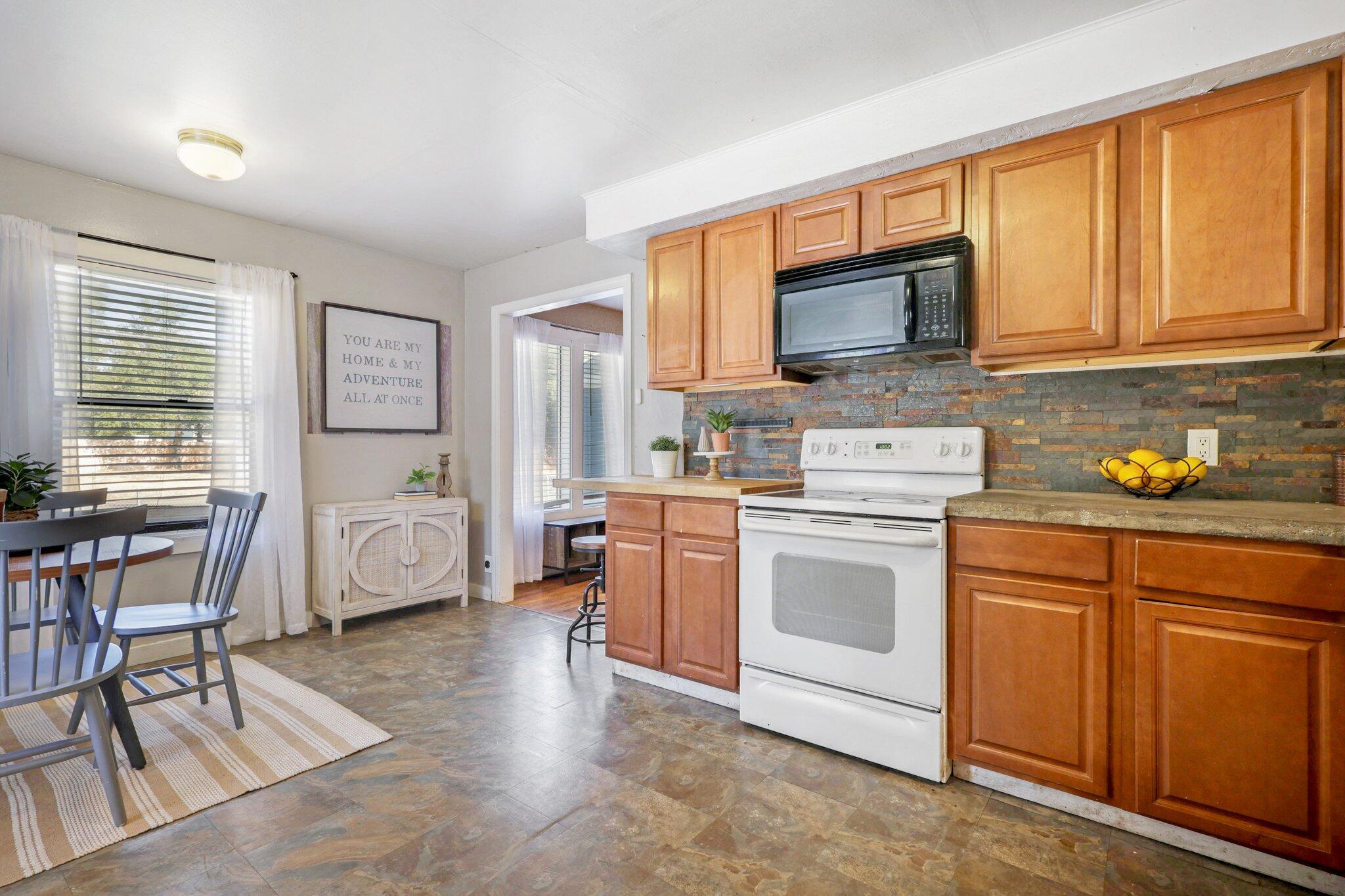 7699 Happy Valley Road Anderson, CA 96007 - Photo 27 of 49 a kitchen with a stove a sink and a microwave