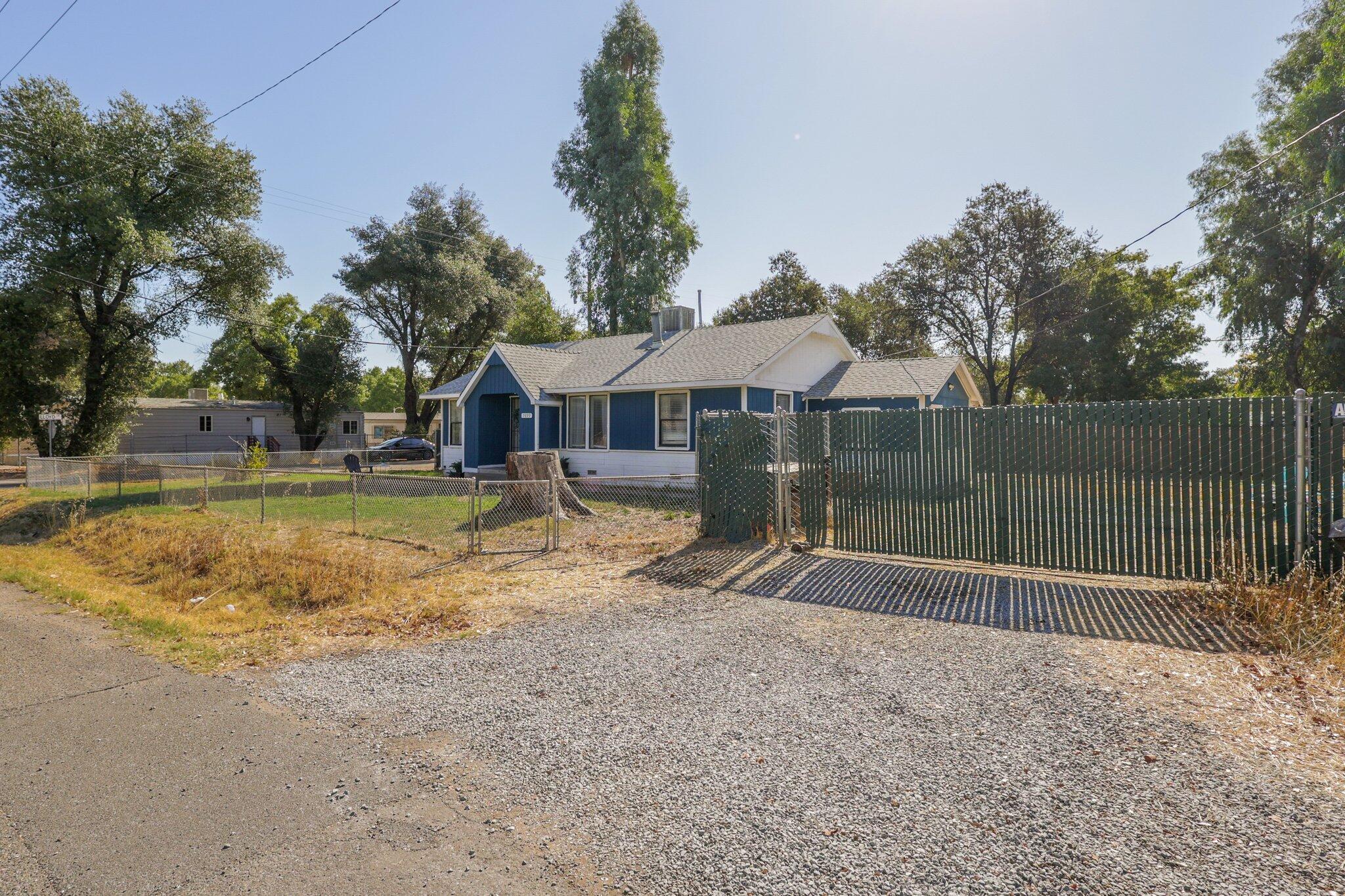 7699 Happy Valley Road Anderson, CA 96007 - Photo 38 of 49 a backyard of a house with lots of green space
