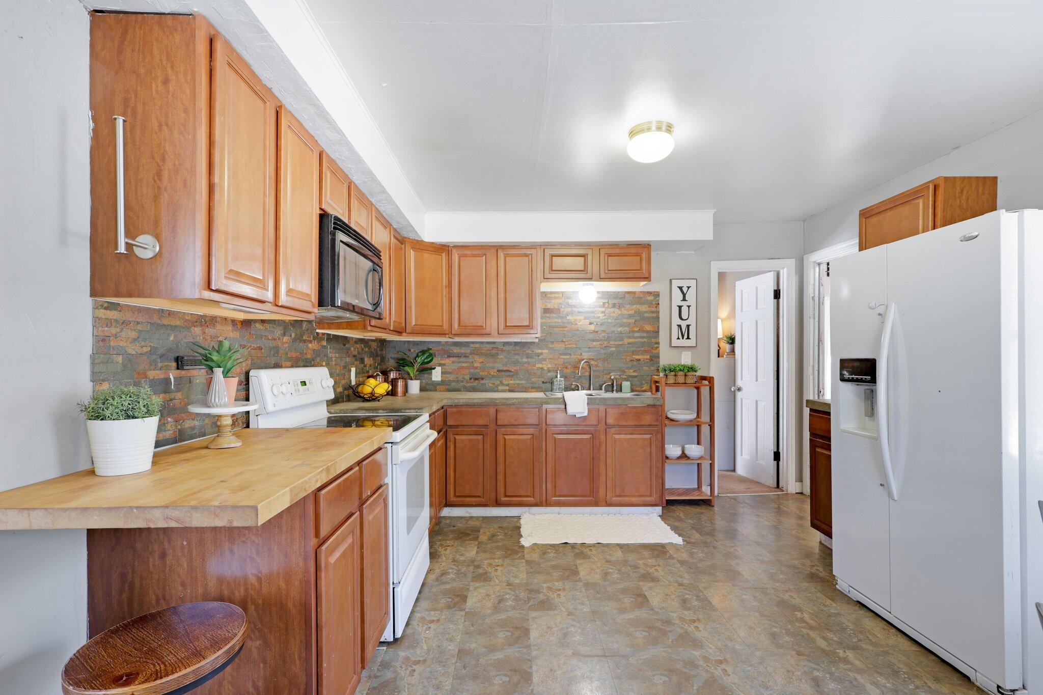 7699 Happy Valley Road Anderson, CA 96007 - Photo 4 of 49 a kitchen with stainless steel appliances granite countertop a refrigerator a stove and a sink