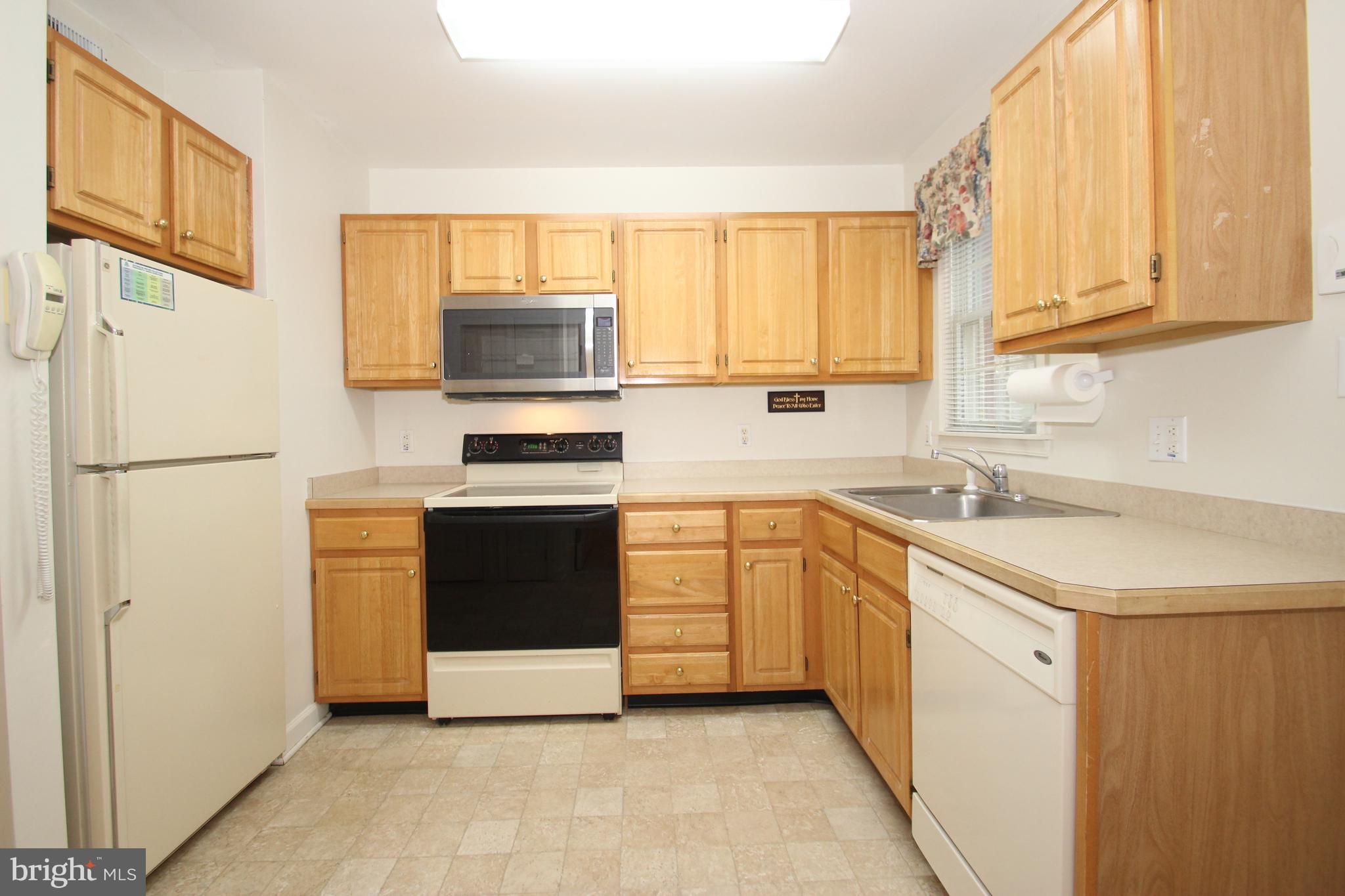 30 West Village Road Newark, DE 19713 - Photo 4 of 13 a kitchen with stainless steel appliances a stove sink and a refrigerator