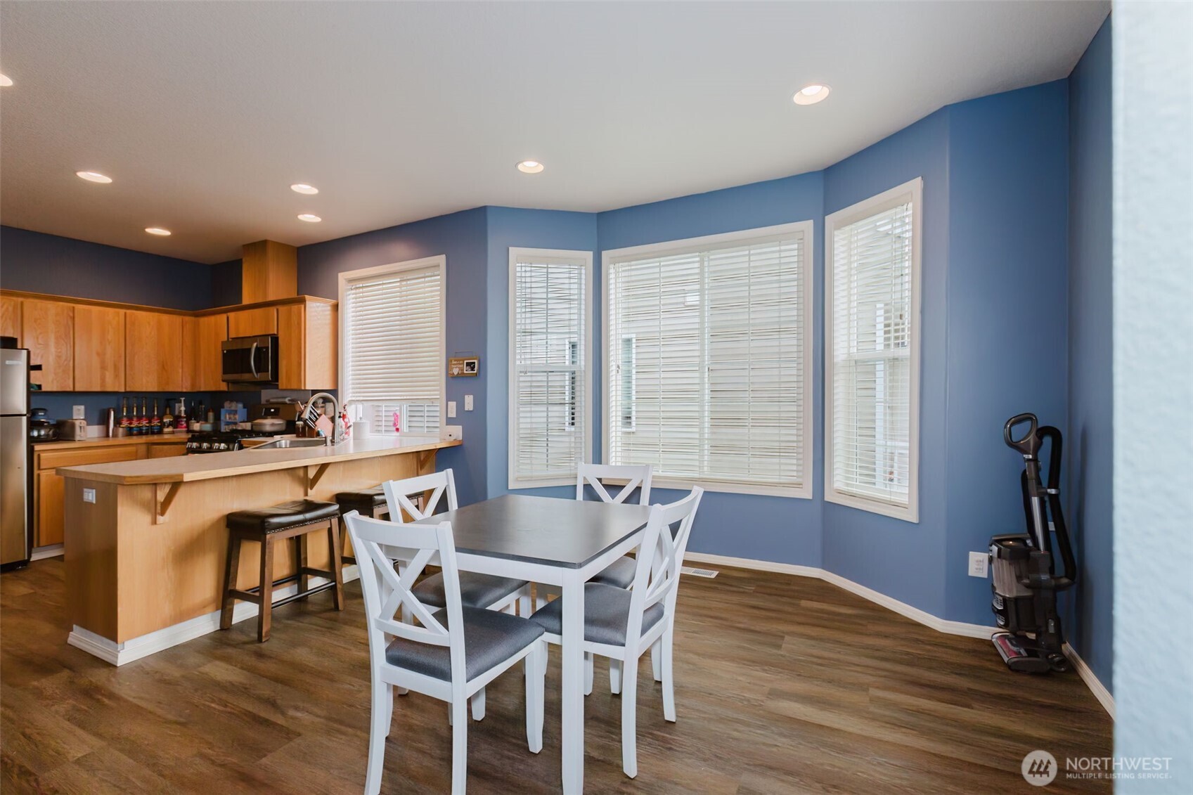 8324 Sweetbrier Loop Southeast Olympia, WA 98513 - Photo 11 of 39 a kitchen with stainless steel appliances granite countertop a kitchen island hardwood floor sink stove dining table and chairs