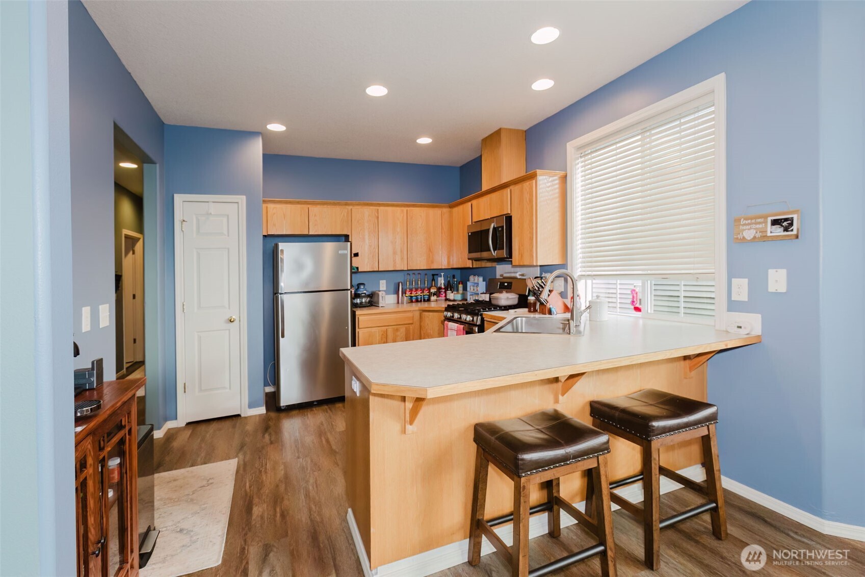 8324 Sweetbrier Loop Southeast Olympia, WA 98513 - Photo 13 of 39 a kitchen with stainless steel appliances granite countertop a sink refrigerator and cabinets