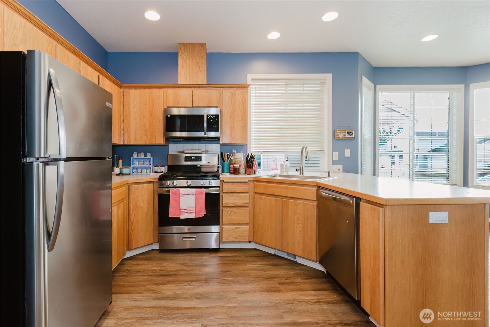 8324 Sweetbrier Loop Southeast Olympia, WA 98513 - Photo 14 of 39 a kitchen with granite countertop a refrigerator stove top oven and sink