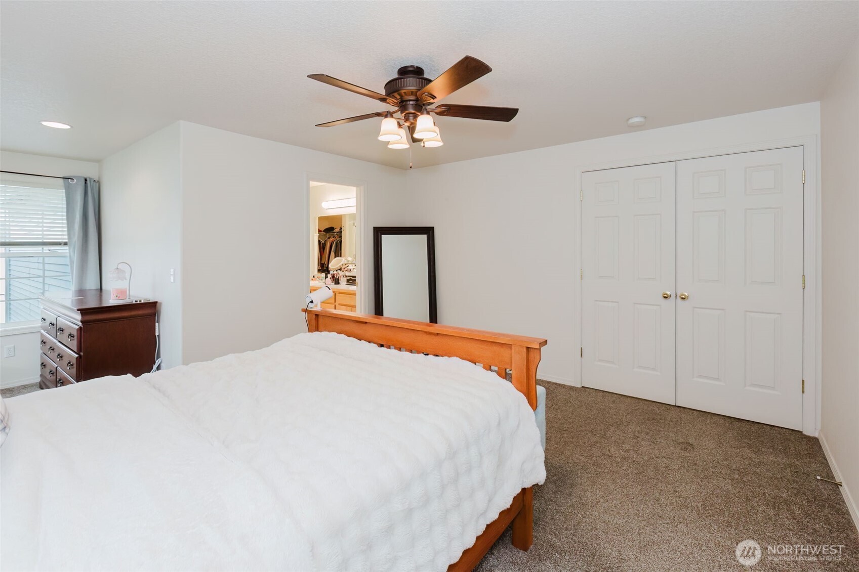 8324 Sweetbrier Loop Southeast Olympia, WA 98513 - Photo 21 of 39 a bedroom with a large bed and a chandelier