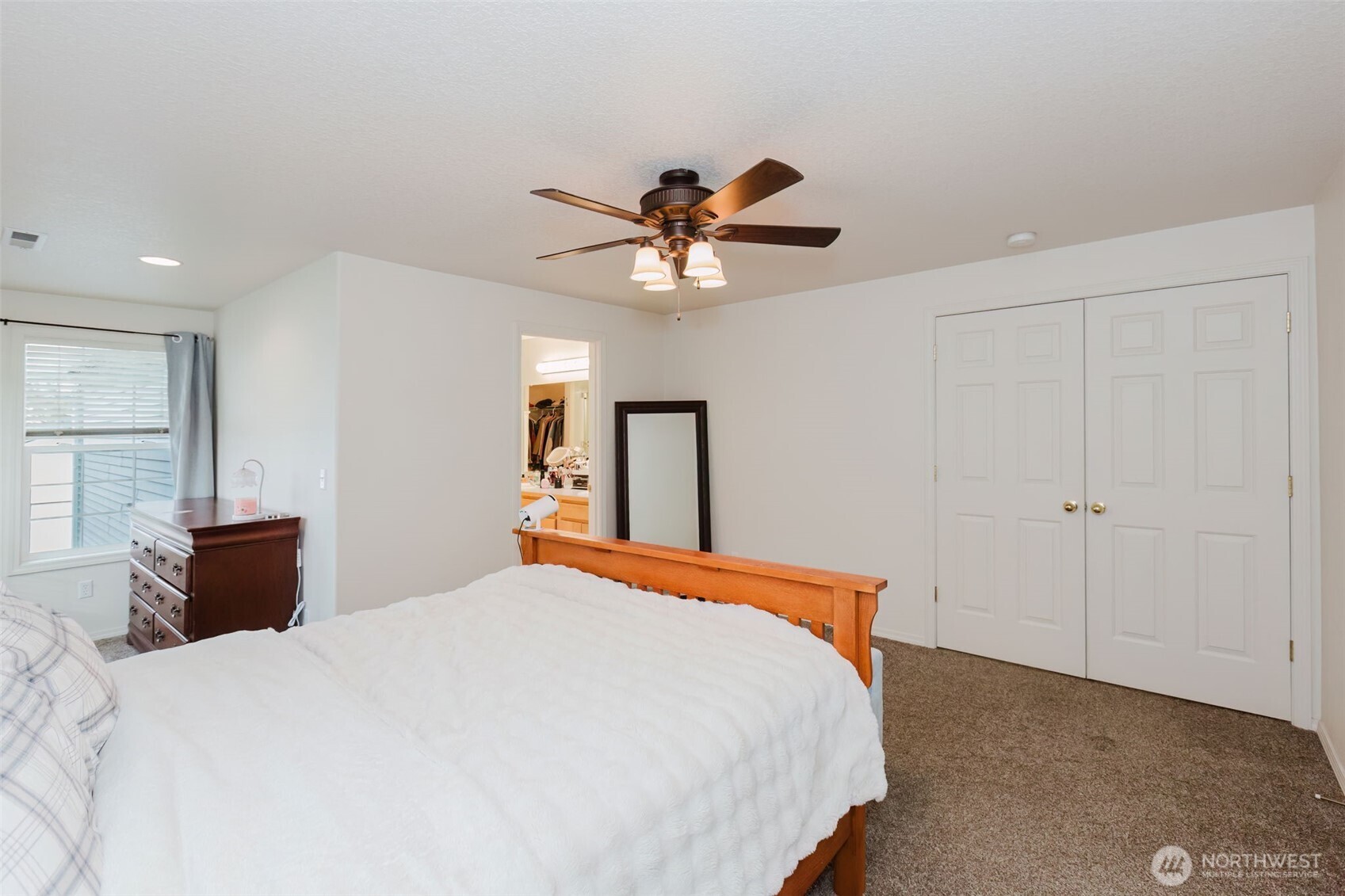 8324 Sweetbrier Loop Southeast Olympia, WA 98513 - Photo 22 of 39 a bedroom with a bed and a chandelier