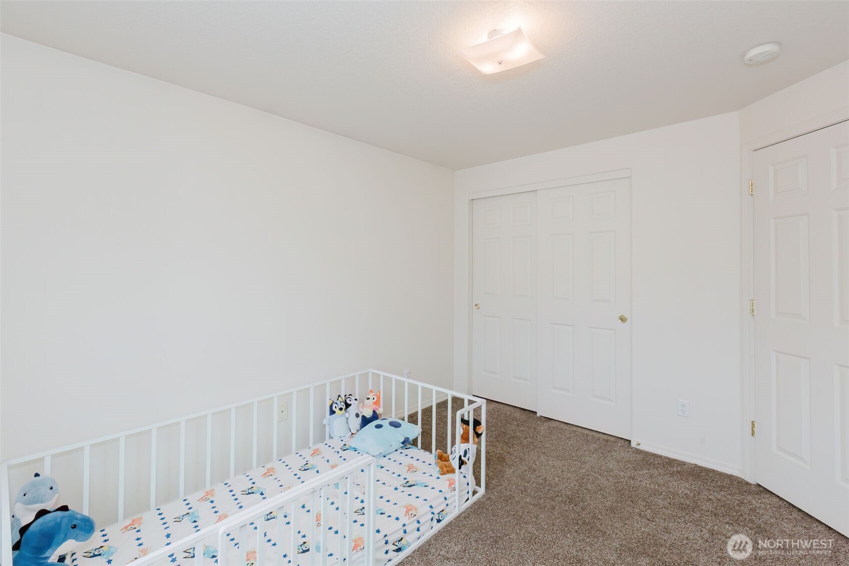 8324 Sweetbrier Loop Southeast Olympia, WA 98513 - Photo 27 of 39 a bedroom with a bed and wooden floor