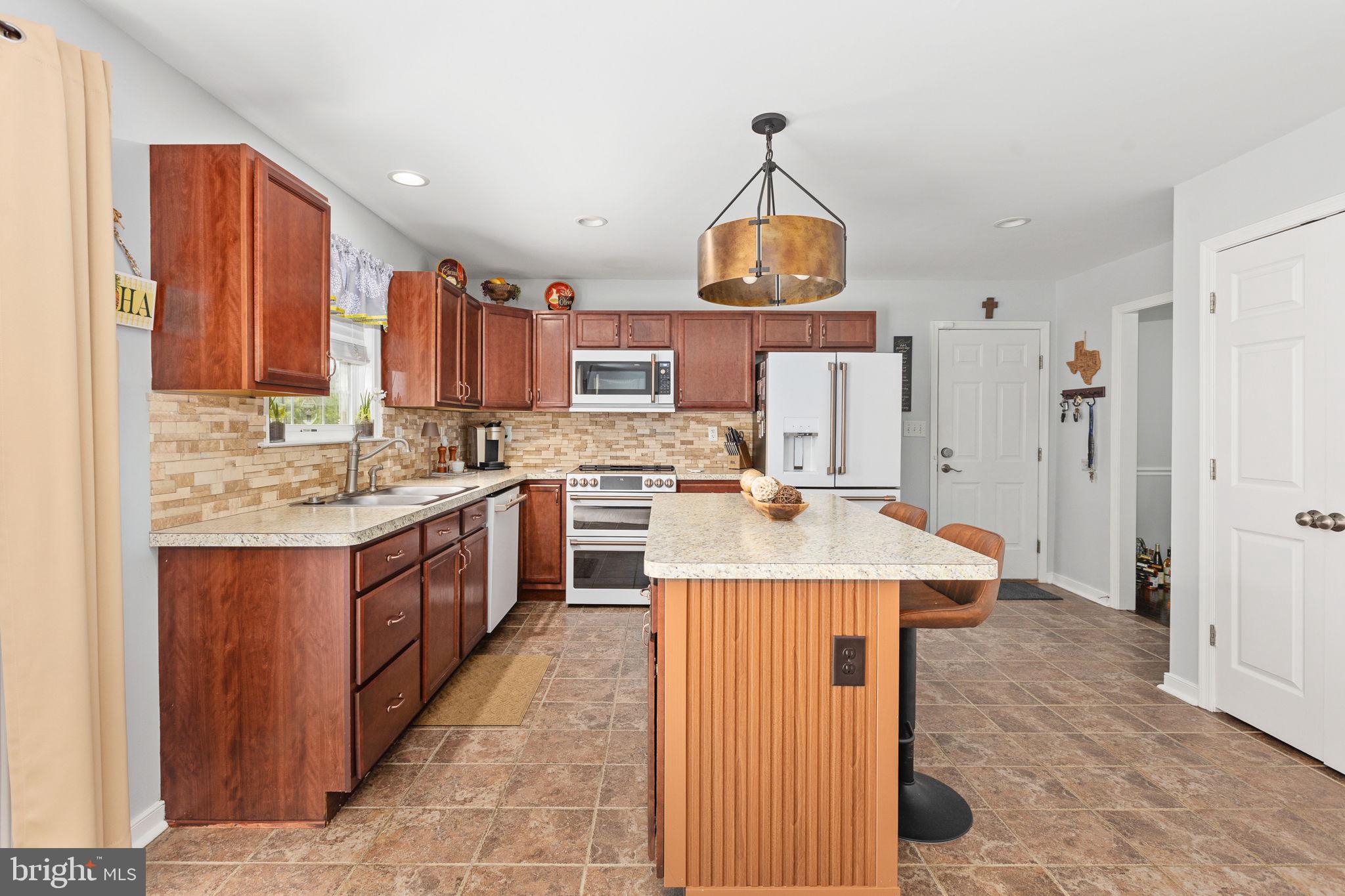 22088 Landora Bridge Road Ruther Glen, VA 22546 - Photo 48 of 122 Modern kitchen with warm wood tones.