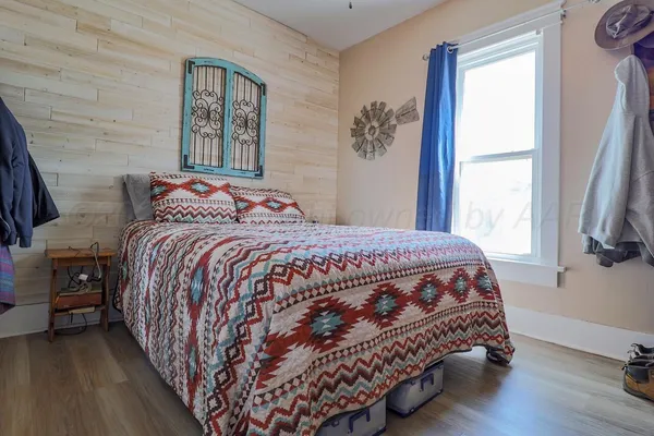 a spacious bedroom with bed and a chandelier