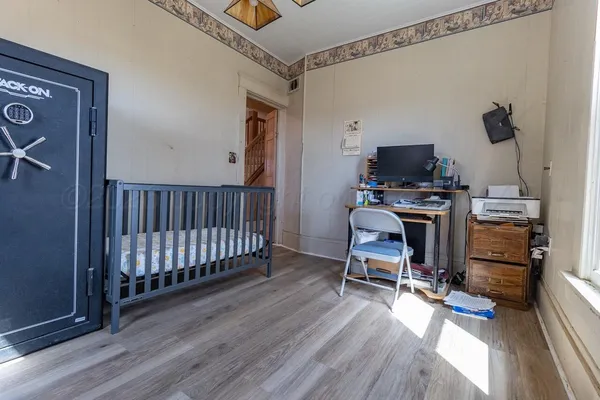 a bedroom with furniture and a large window