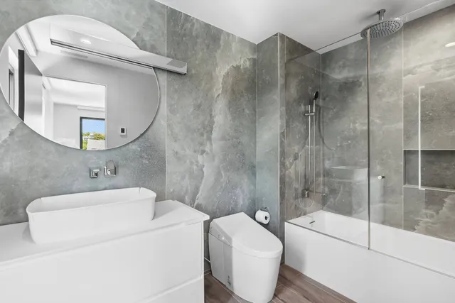 a bathroom with a toilet sink and shower