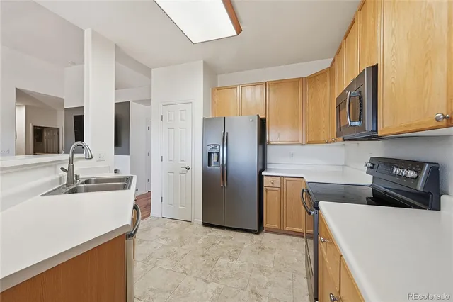 a kitchen with a refrigerator sink and stove