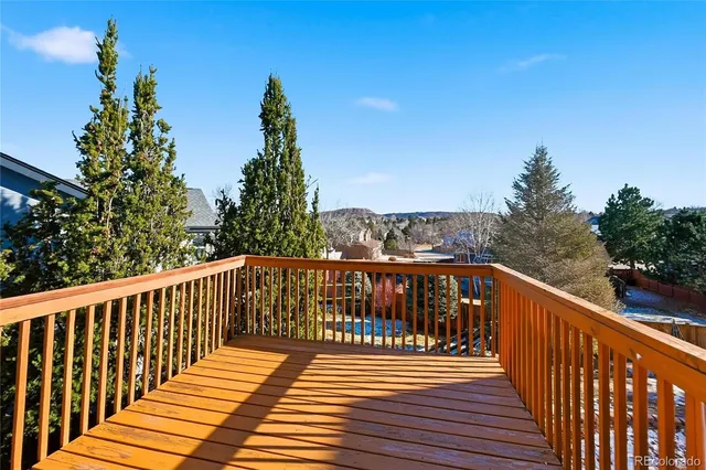 a balcony with wooden floor and fence
