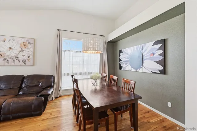 a view of a dining room with furniture window and wooden floor