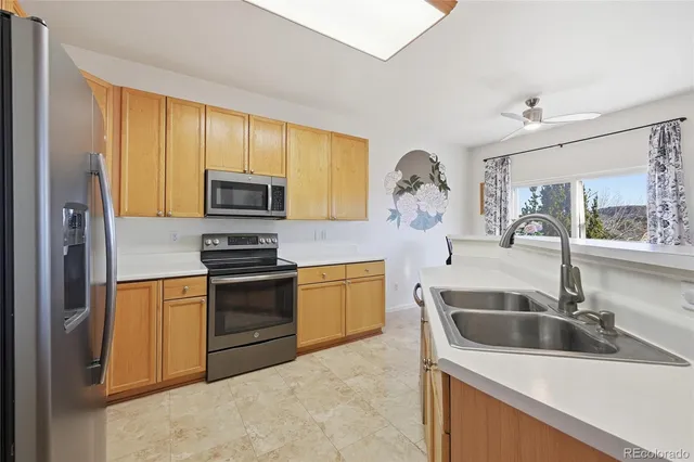 a kitchen with a sink and a stove top oven