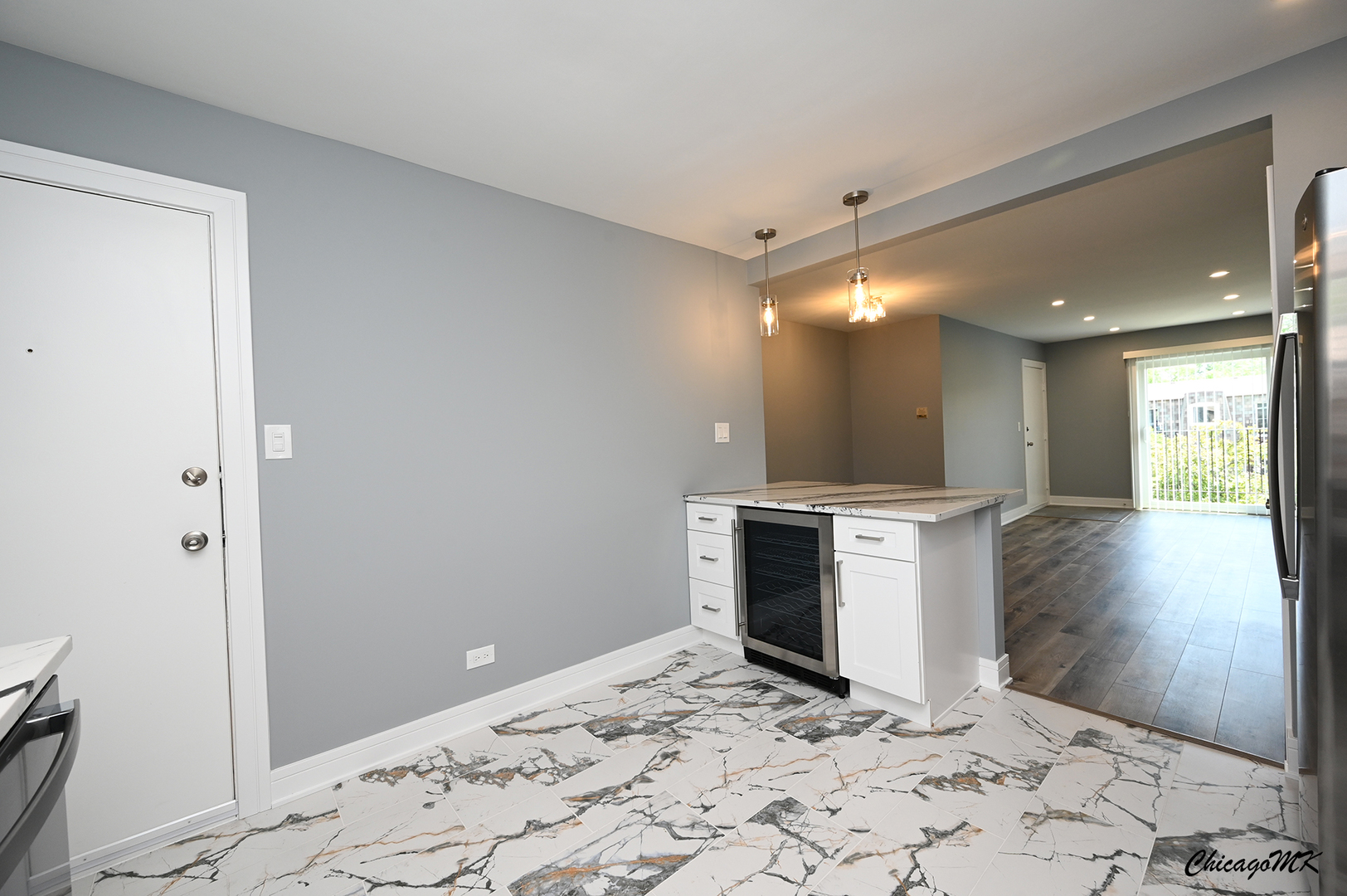 9381 Bay Colony Drive, Unit 3S Des Plaines, IL 60016 - Photo 19 of 43 a view of a hallway with wooden floor and a kitchen space