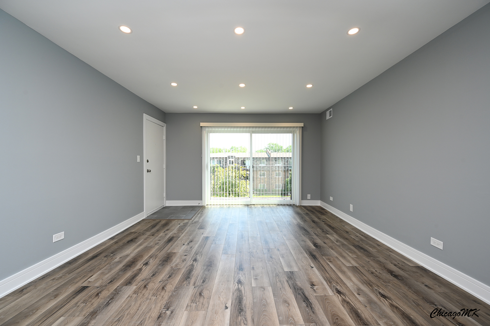 9381 Bay Colony Drive, Unit 3S Des Plaines, IL 60016 - Photo 2 of 43 a view of an empty room with wooden floor and a window