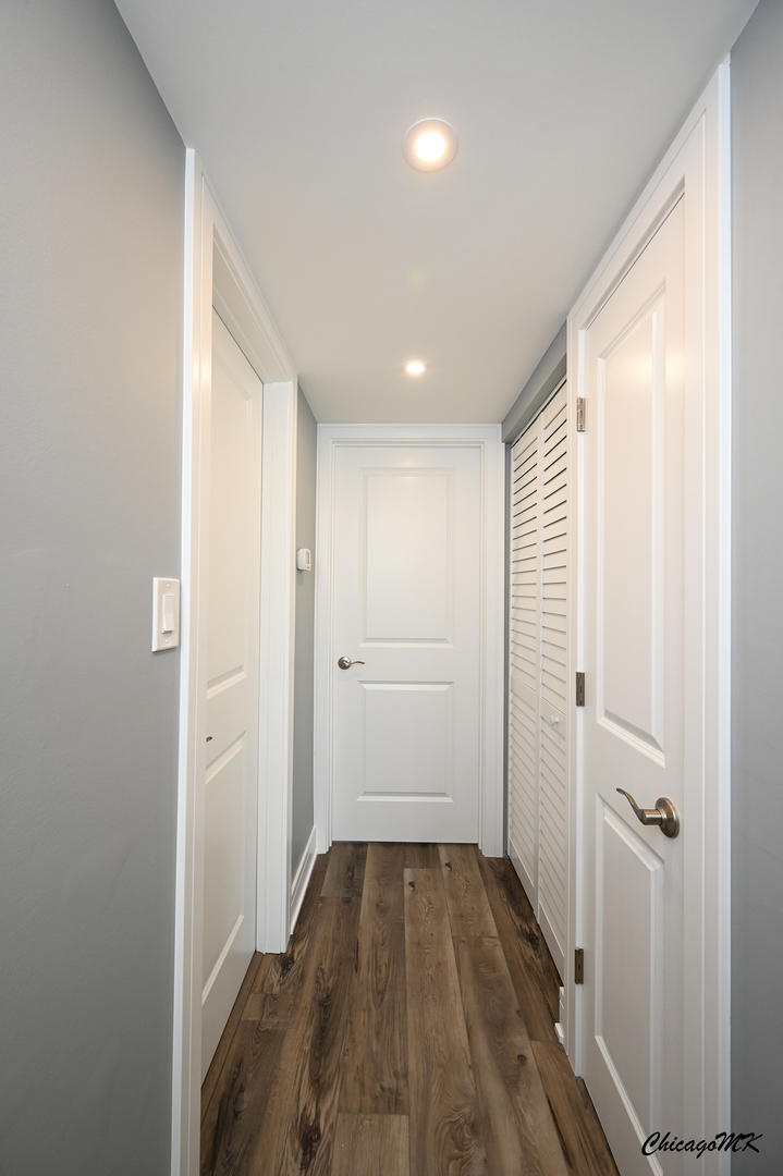 9381 Bay Colony Drive, Unit 3S Des Plaines, IL 60016 - Photo 22 of 43 a view of a hallway with wooden floor and closet area
