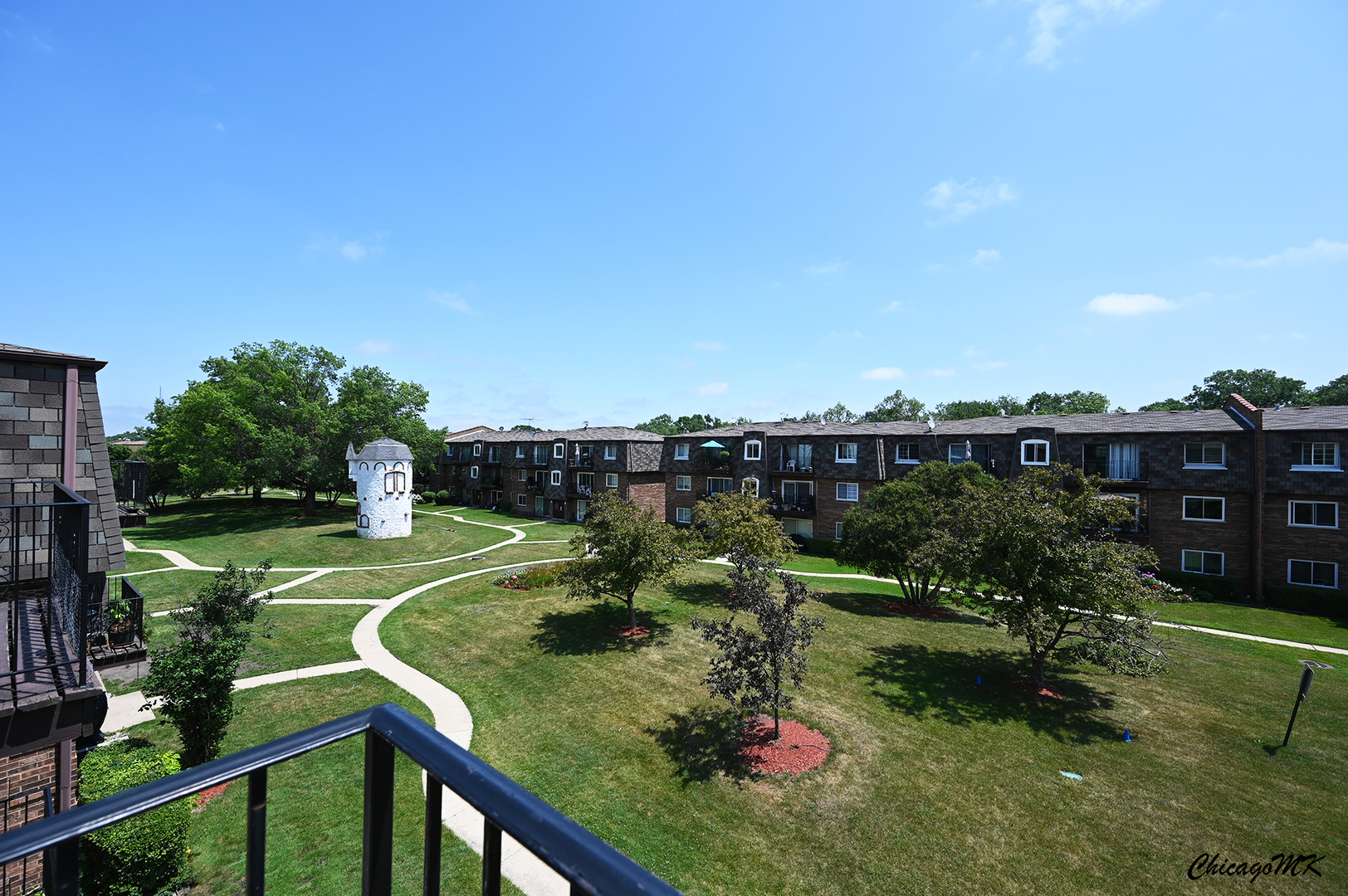 9381 Bay Colony Drive, Unit 3S Des Plaines, IL 60016 - Photo 33 of 43 a view of a house with a yard and potted plants