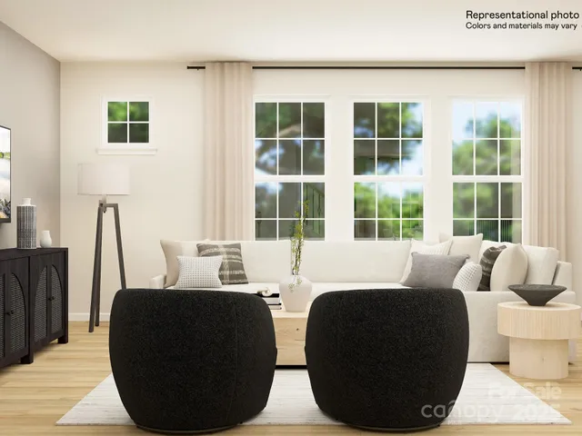 a living room with couches a coffee table and a large window