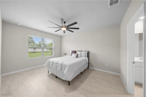 a bed sitting in a bedroom next to a window