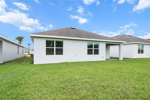a view of a house with a backyard