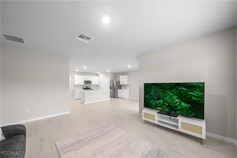 a view of a living room and kitchen with furniture
