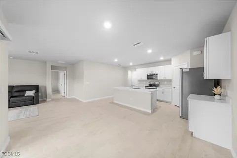 a view of kitchen with furniture and refrigerator