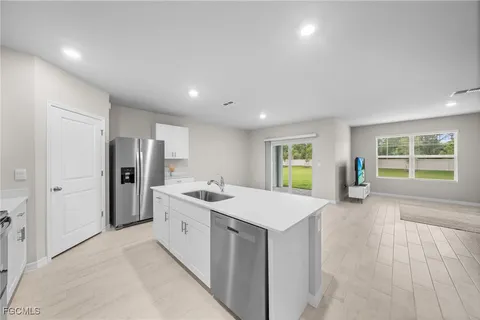 a view of a kitchen with a sink and a window