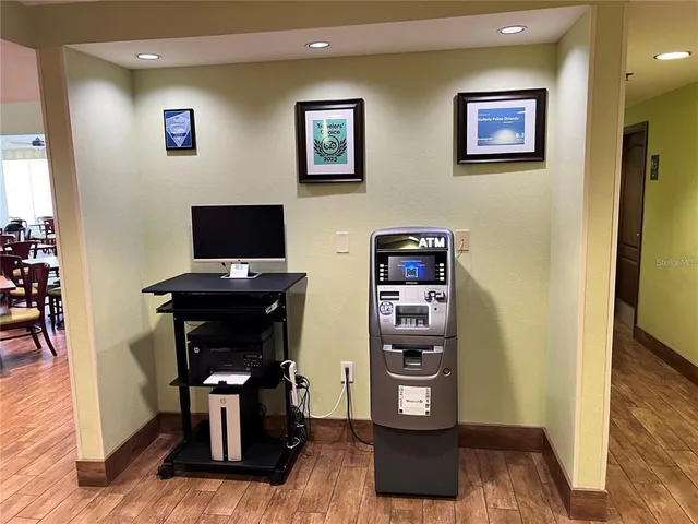 a view of a workspace with furniture and wooden floor