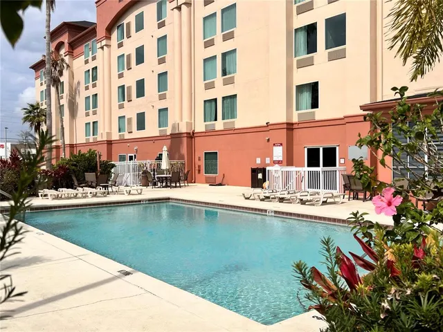 a view of a swimming pool with a lounge chair
