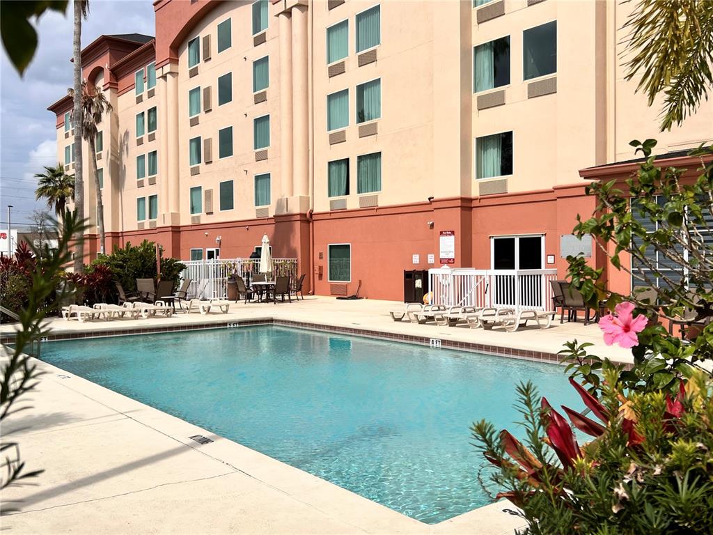 3000 Maingate Lane, Unit 507 Kissimmee, FL 34747 - Photo 2 of 16 a view of a swimming pool with a lounge chair