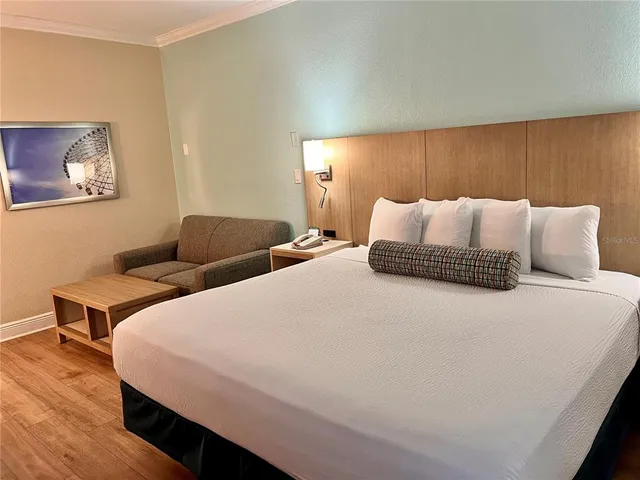 a bedroom with a bed and a night stand