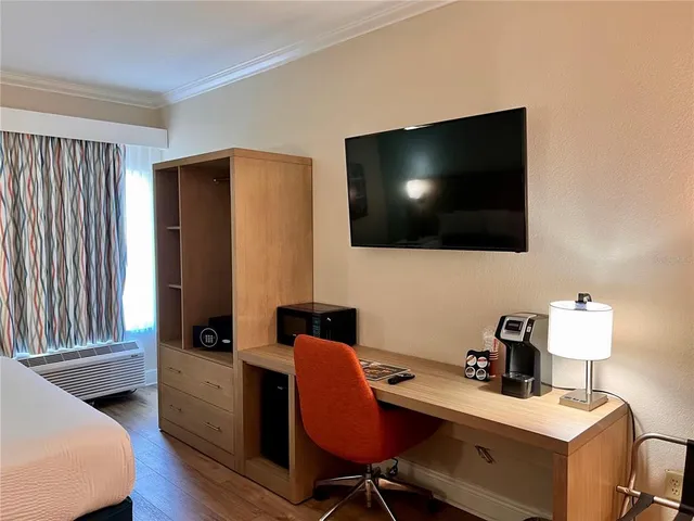 a view of a workspace with furniture and a flat screen tv