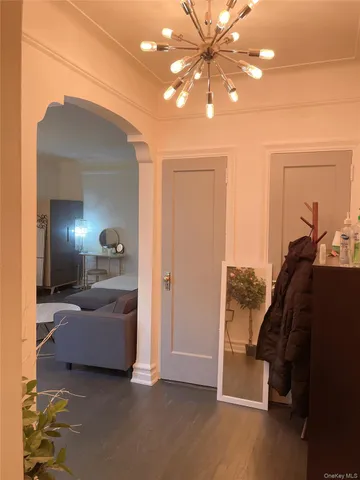 a living room with furniture and a chandelier