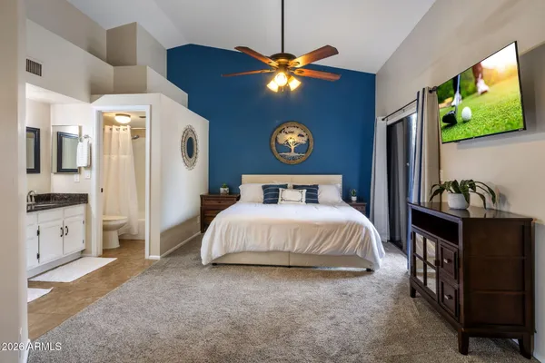 a bedroom with a bed and a chandelier