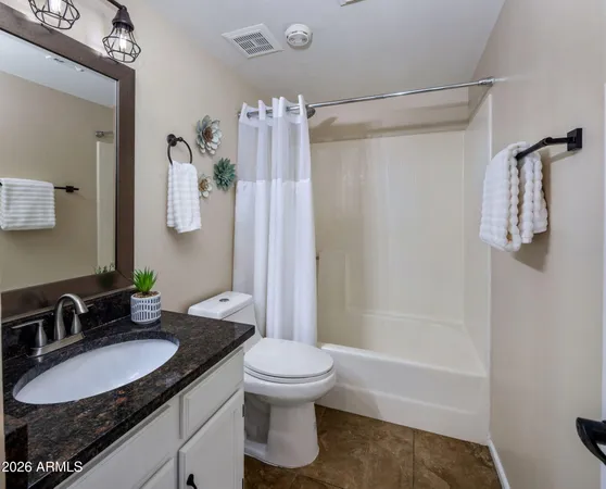 a bathroom with double sink and a mirror