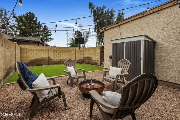 a view of a patio with table and chairs and potted plants