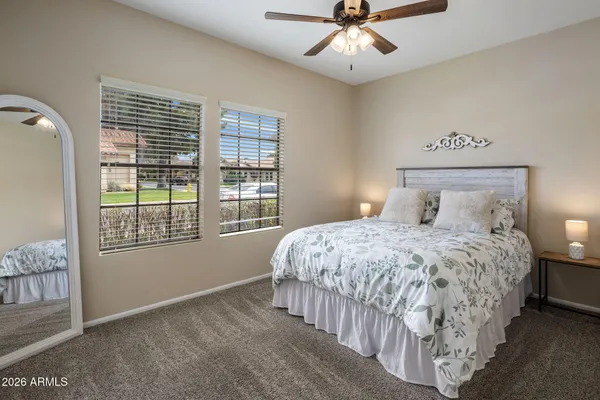 a living room with furniture a flat screen tv and a rug