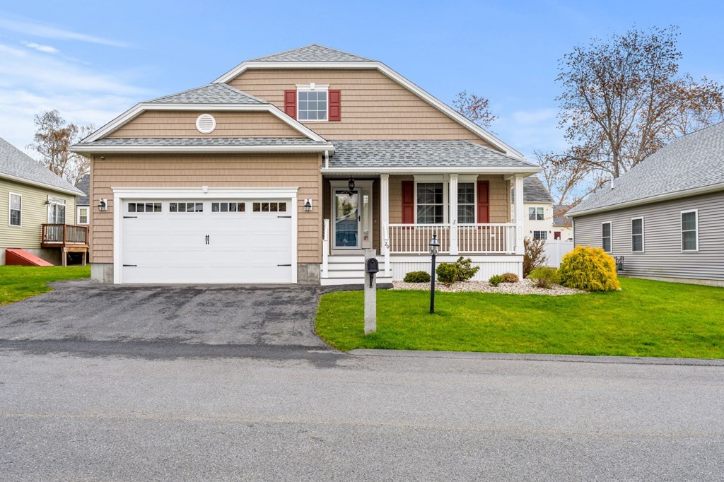 20 Paddock Circle, Unit 20 Salem, NH 03079 - Photo 1 of 29 a front view of a house with a yard and garage