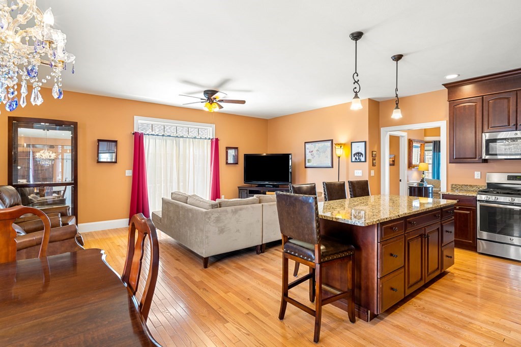 20 Paddock Circle, Unit 20 Salem, NH 03079 - Photo 11 of 29 a living room with furniture a flat screen tv and kitchen view