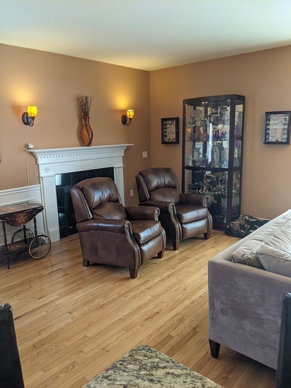 20 Paddock Circle, Unit 20 Salem, NH 03079 - Photo 13 of 29 a living room with furniture and wooden floor