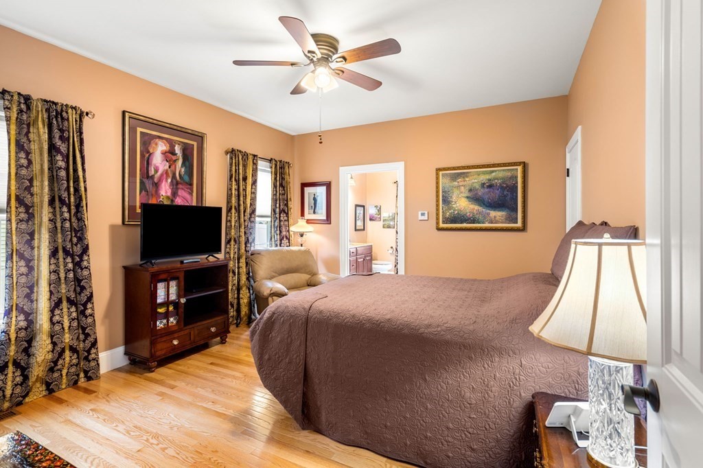 20 Paddock Circle, Unit 20 Salem, NH 03079 - Photo 14 of 29 a bedroom with a bed and a flat screen tv