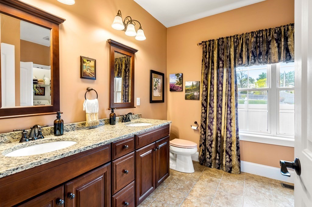 20 Paddock Circle, Unit 20 Salem, NH 03079 - Photo 15 of 29 a bathroom with a granite countertop sink and a mirror
