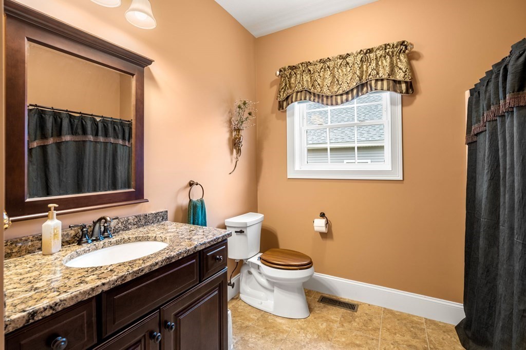 20 Paddock Circle, Unit 20 Salem, NH 03079 - Photo 17 of 29 a bathroom with a granite countertop sink and a toilet