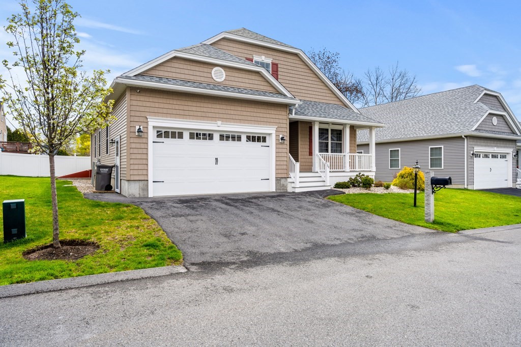 20 Paddock Circle, Unit 20 Salem, NH 03079 - Photo 2 of 29 a view of a house with a small yard and plants