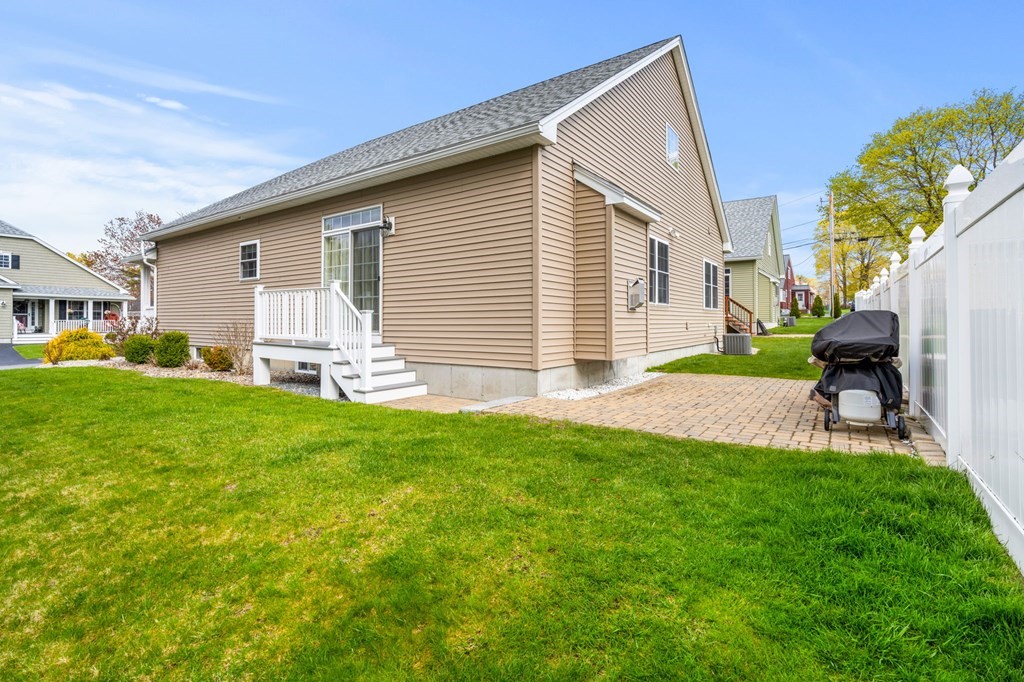 20 Paddock Circle, Unit 20 Salem, NH 03079 - Photo 3 of 29 a front view of house with yard and outdoor seating