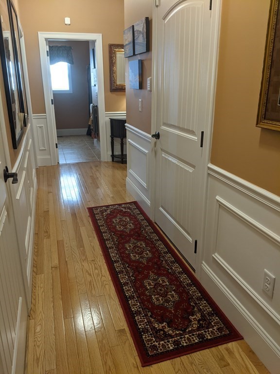 20 Paddock Circle, Unit 20 Salem, NH 03079 - Photo 10 of 29 a room with wooden floor and furniture