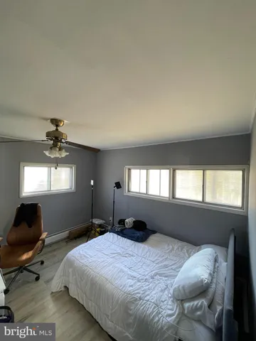 a bedroom with bed window and furniture